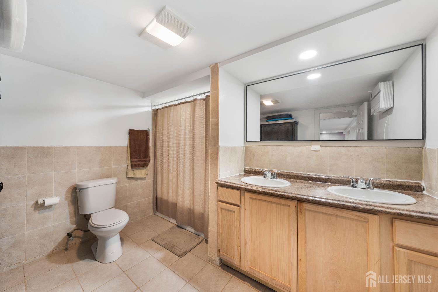 479 Chain O' Hills Road Colonia, NJ 07067 - Photo 12 of 18 a bathroom with a granite countertop sink a toilet and a mirror