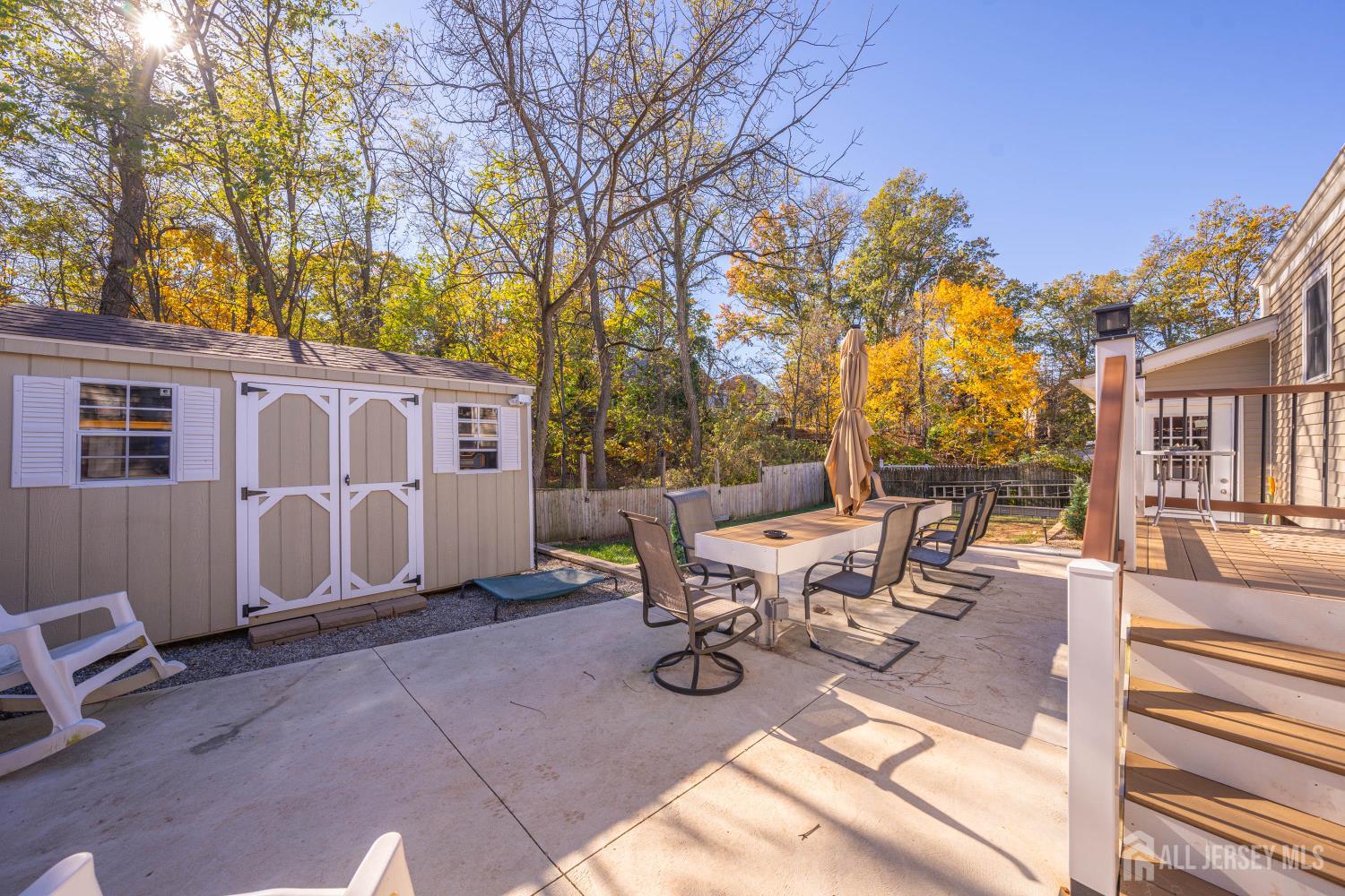 479 Chain O' Hills Road Colonia, NJ 07067 - Photo 13 of 18 a view of a patio with table and chairs with wooden fence and floor