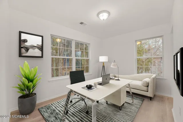 a living room with furniture a lamp a potted plant and a table