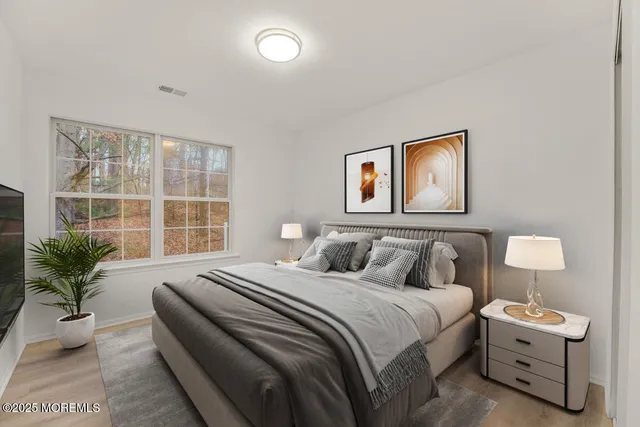 a bedroom with a bed and a potted plant