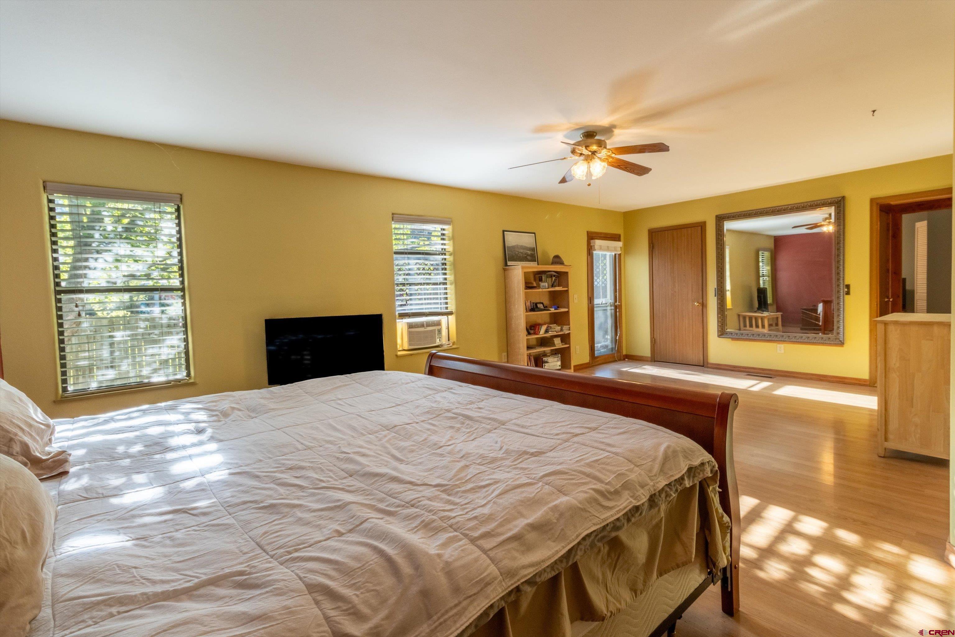 327 Hermosa Circle Durango, CO 81301 - Photo 11 of 32 a bedroom with a bed and dresser with mirror
