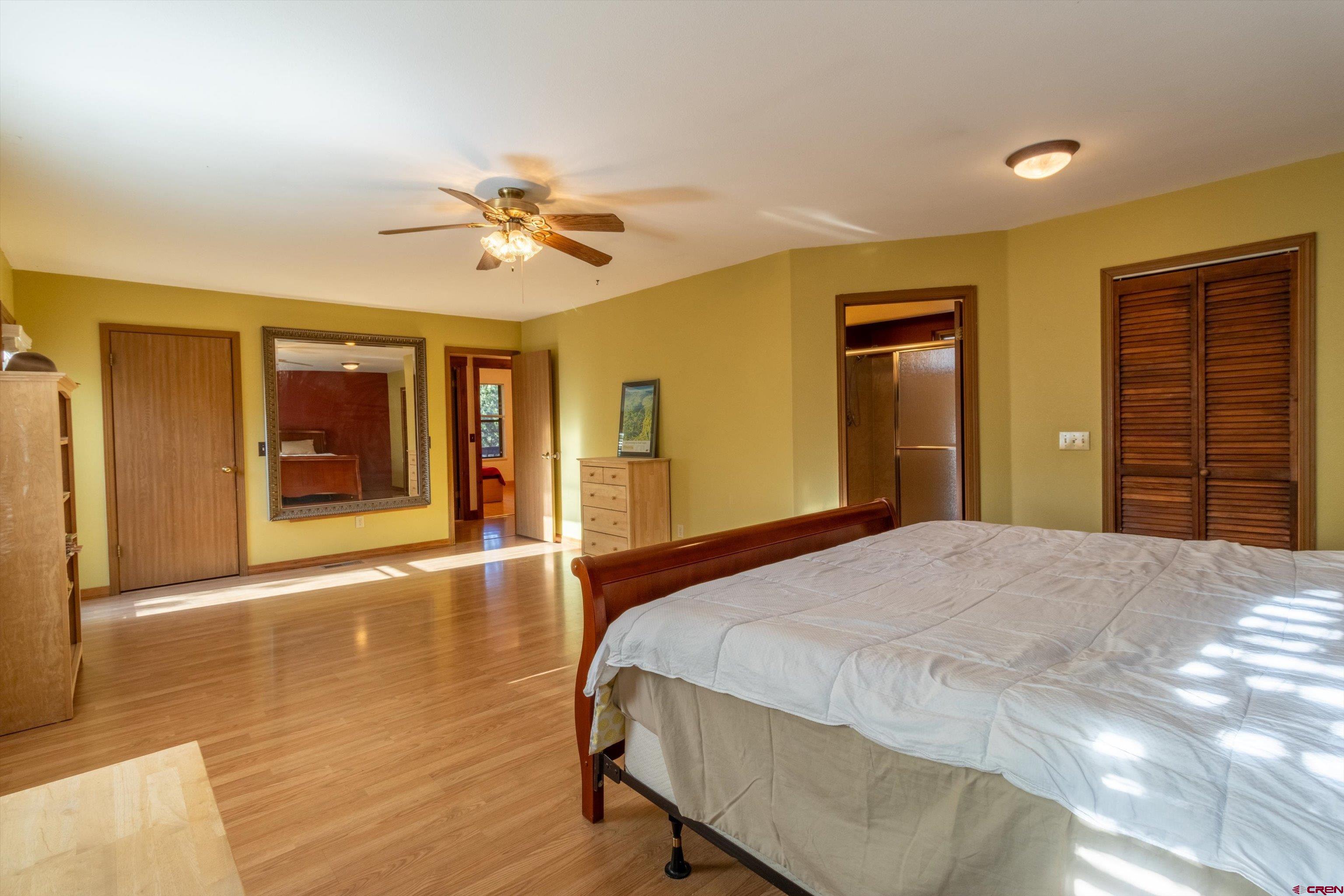 327 Hermosa Circle Durango, CO 81301 - Photo 12 of 32 a bedroom with a bed and a chandelier