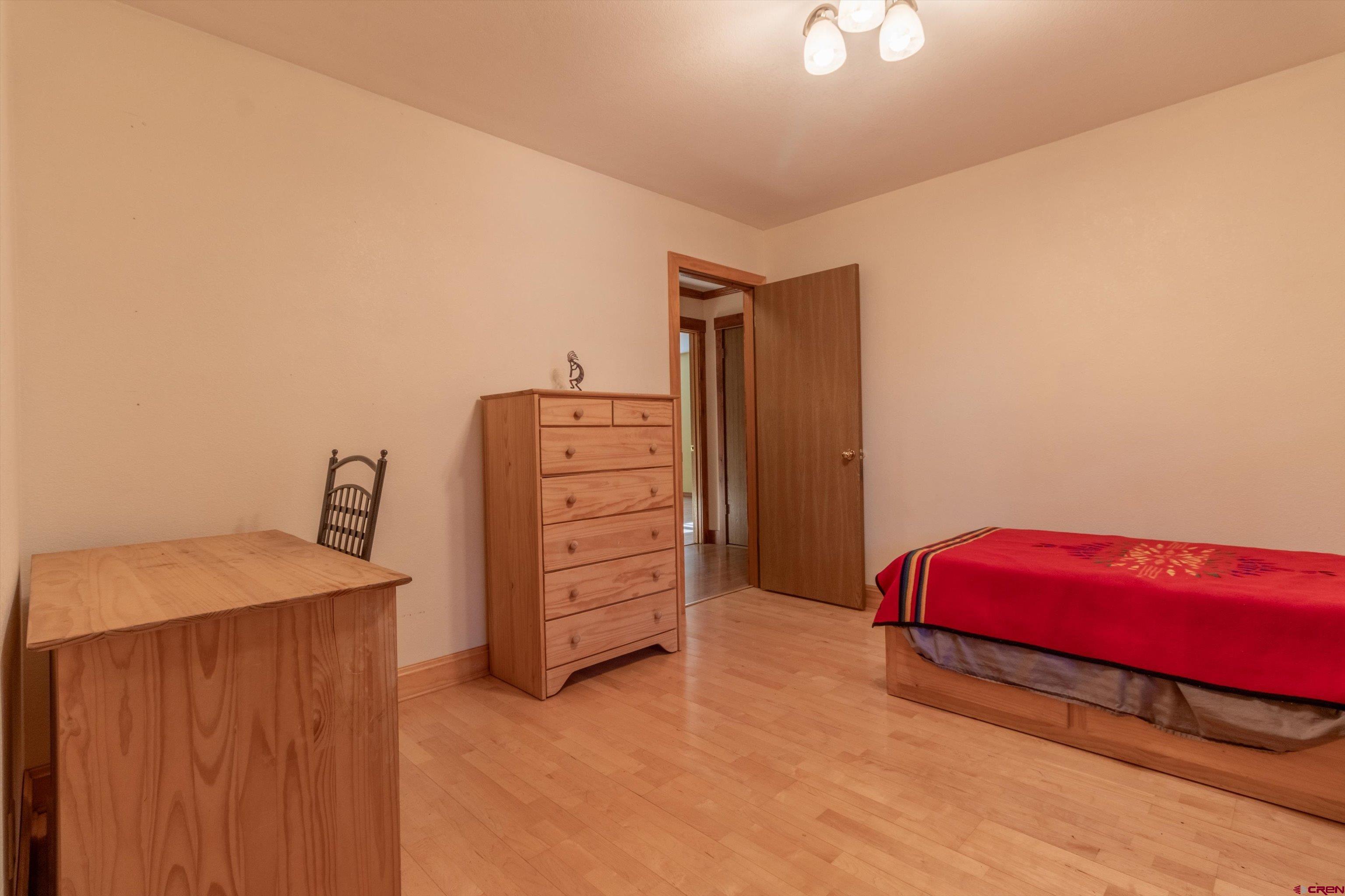 327 Hermosa Circle Durango, CO 81301 - Photo 16 of 32 a bedroom with a bed and a dresser