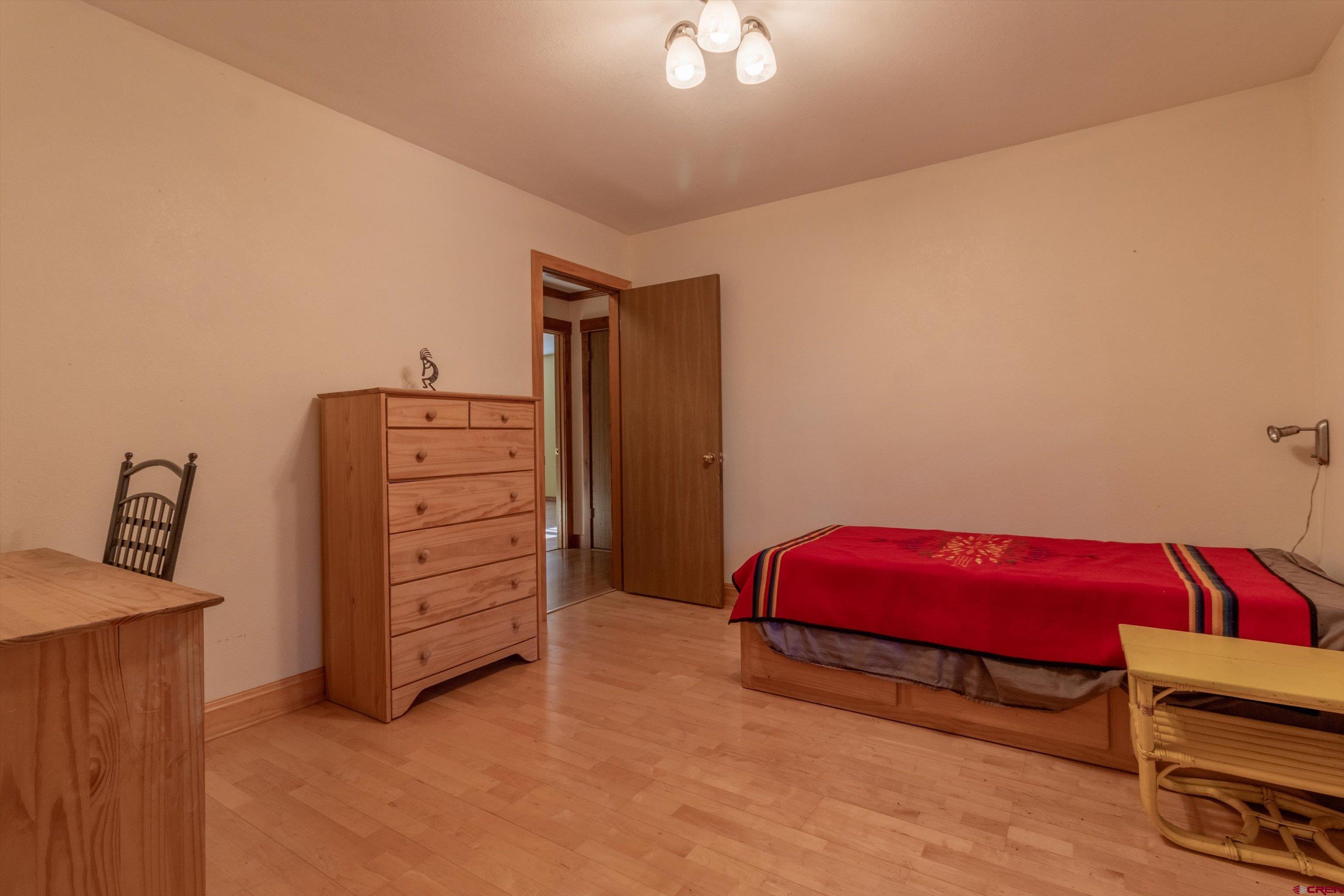 327 Hermosa Circle Durango, CO 81301 - Photo 17 of 32 a bedroom with a bed and a dresser
