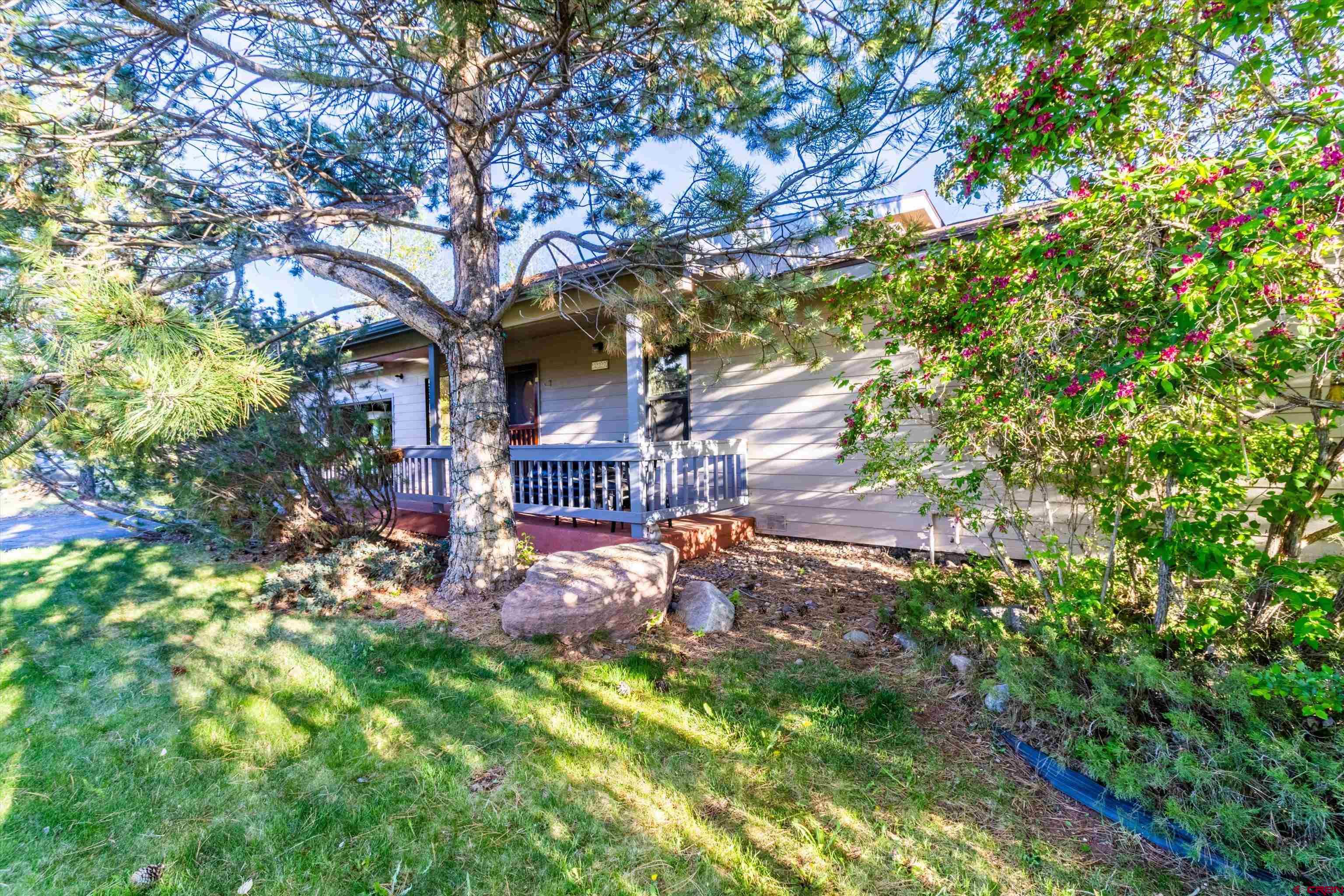 327 Hermosa Circle Durango, CO 81301 - Photo 29 of 32 a view of a backyard with table and chairs and a large tree