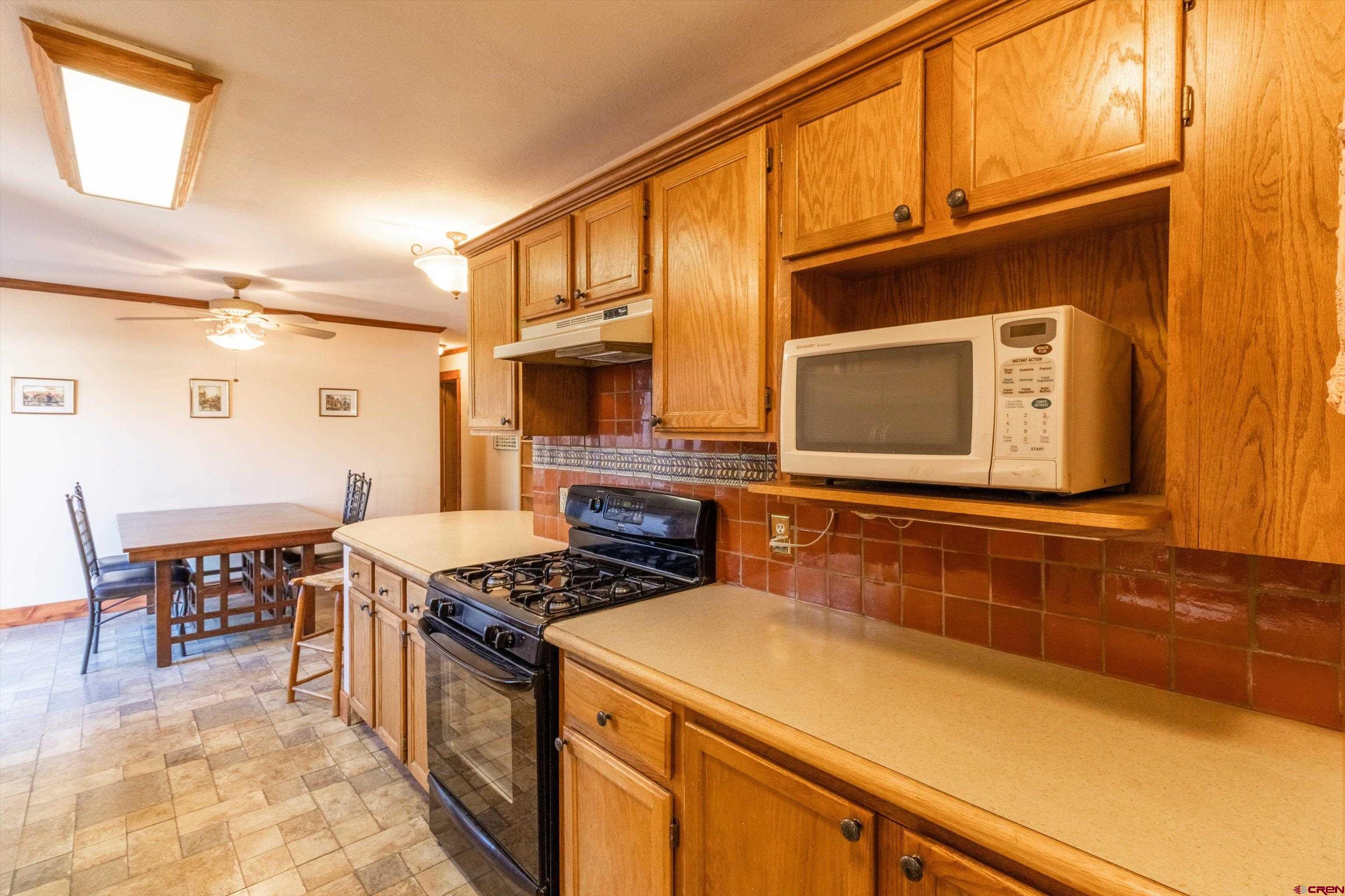 327 Hermosa Circle Durango, CO 81301 - Photo 7 of 32 a kitchen with stainless steel appliances granite countertop a stove and a sink