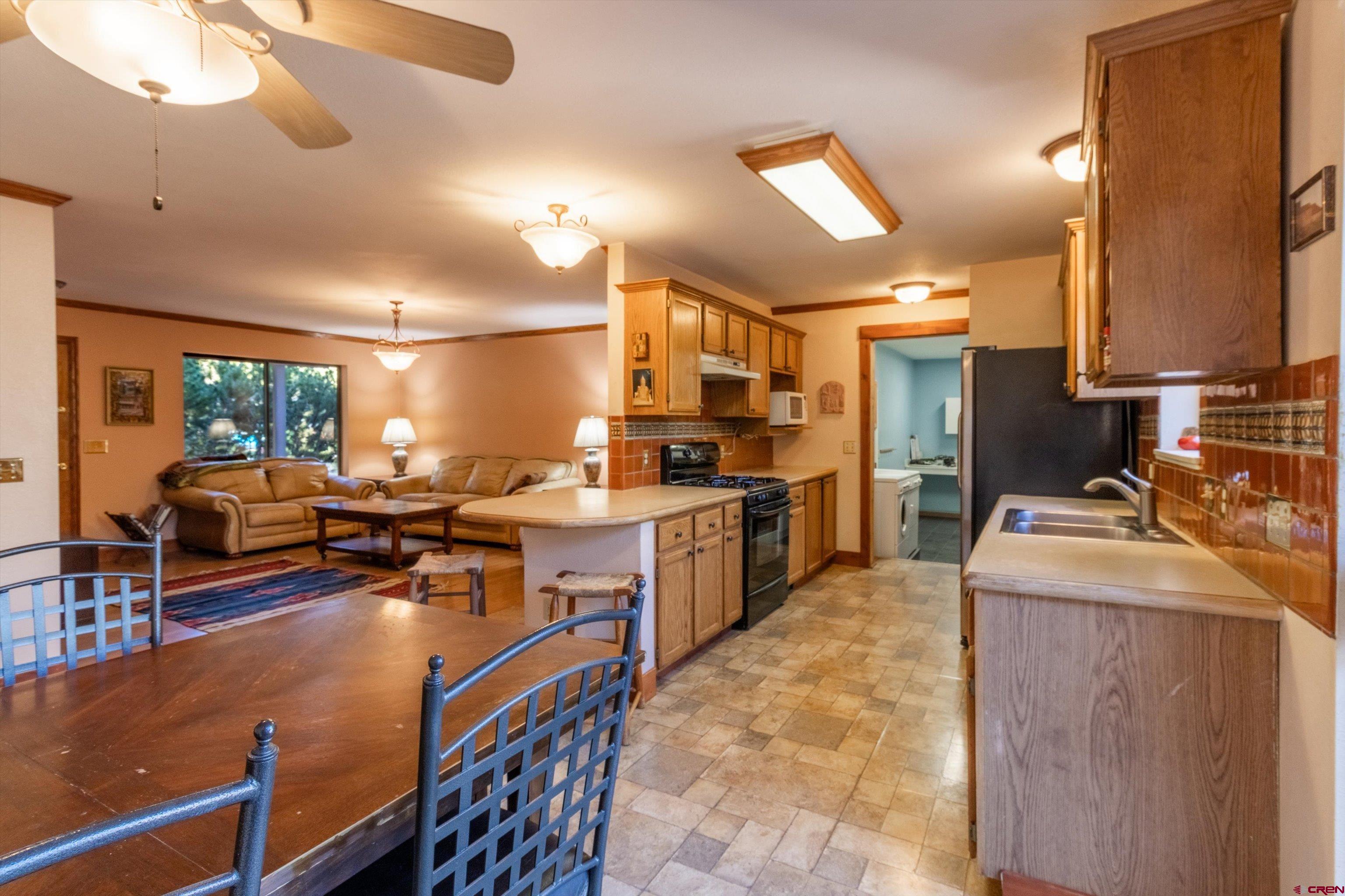 327 Hermosa Circle Durango, CO 81301 - Photo 8 of 32 a kitchen with stainless steel appliances granite countertop sink stove and refrigerator