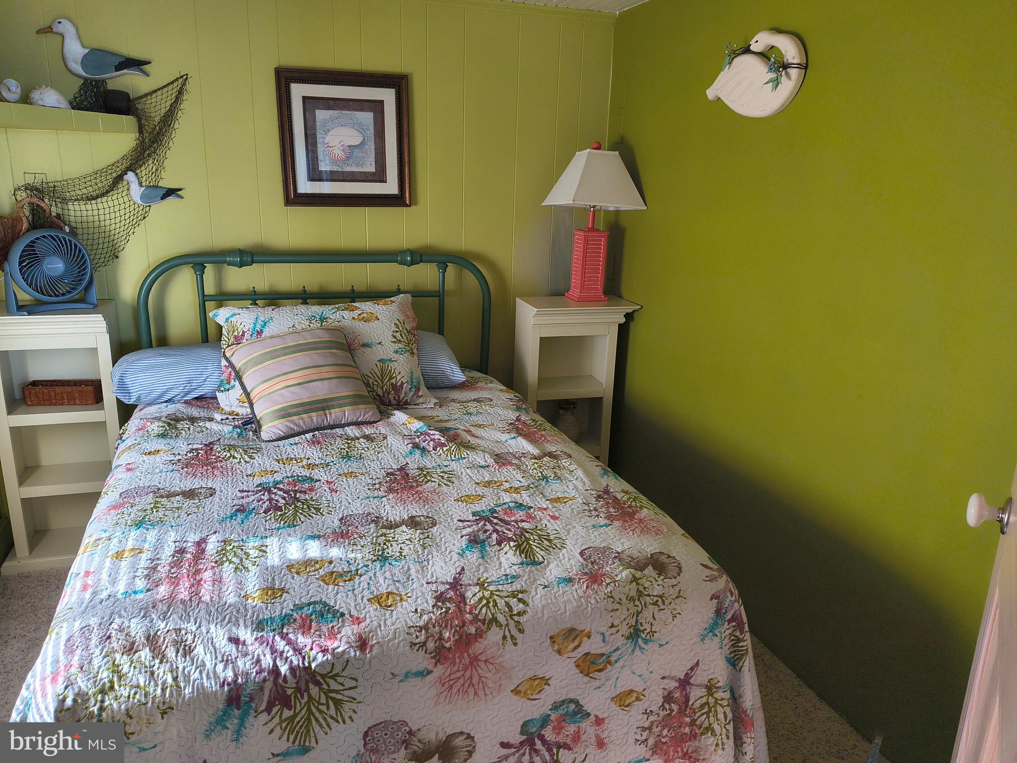 6803 Atlantic Avenue, Unit 4L Ocean City, MD 21842 - Photo 23 of 34 a bedroom with a bed and a lamp on dresser