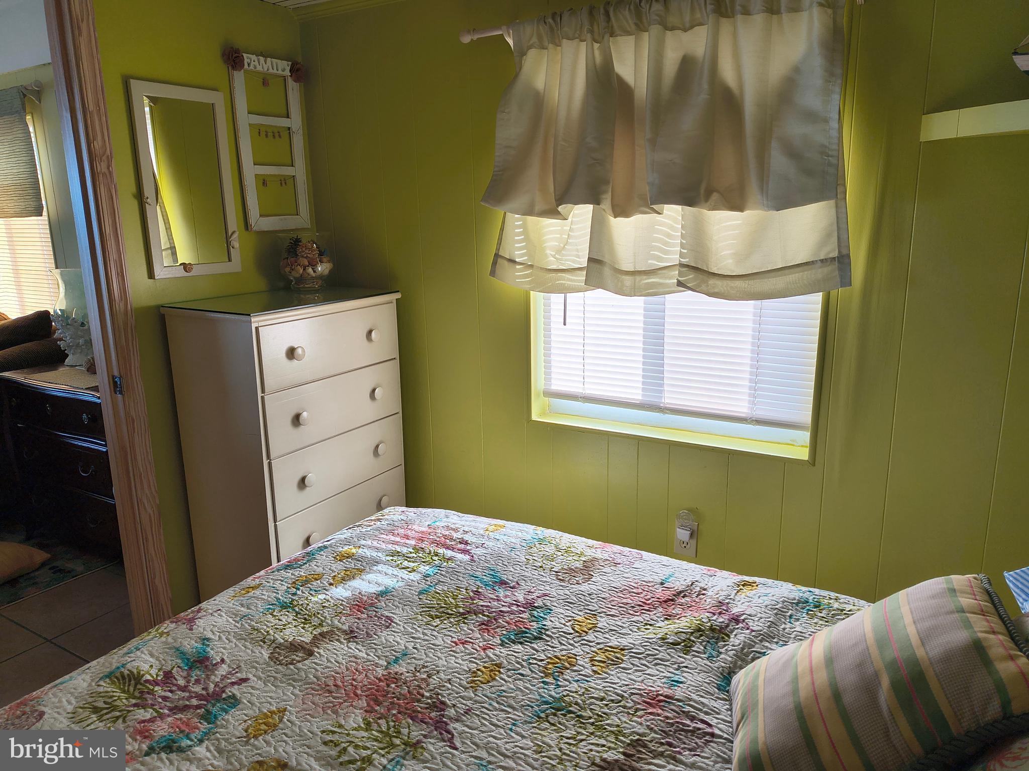 6803 Atlantic Avenue, Unit 4L Ocean City, MD 21842 - Photo 25 of 34 a bedroom with a bed and mirror