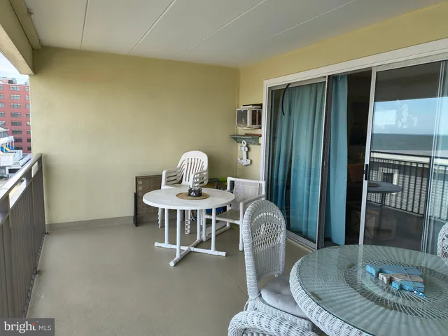 a view of a hallway with wooden floor and livingroom view
