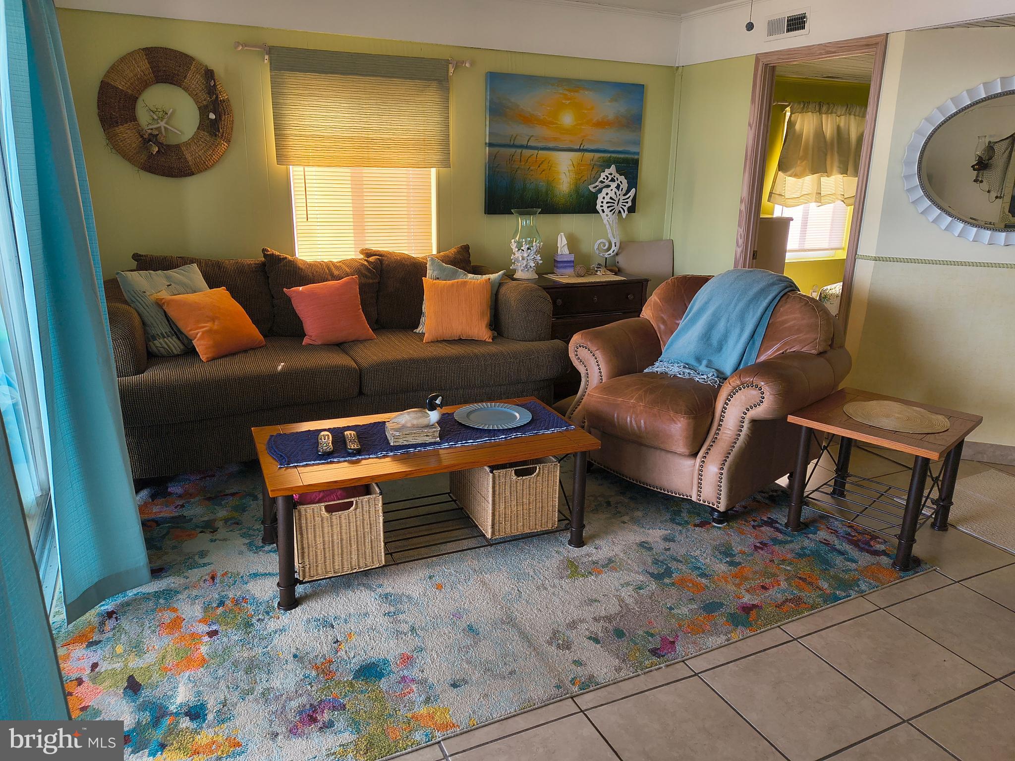 6803 Atlantic Avenue, Unit 4L Ocean City, MD 21842 - Photo 8 of 34 a living room with furniture and a baby crib