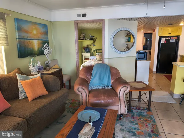 a living room with furniture and a mirror