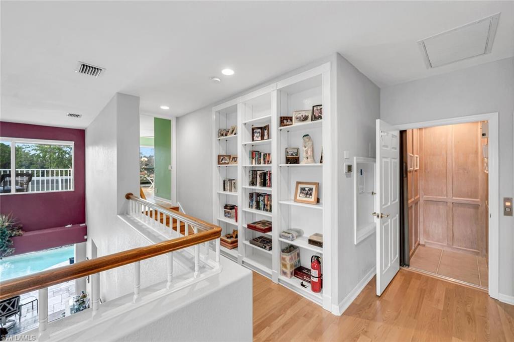 5735 Persimmon Way Naples, FL 34110 - Photo 15 of 49 Hallway with light hardwood / wood-style flooring
