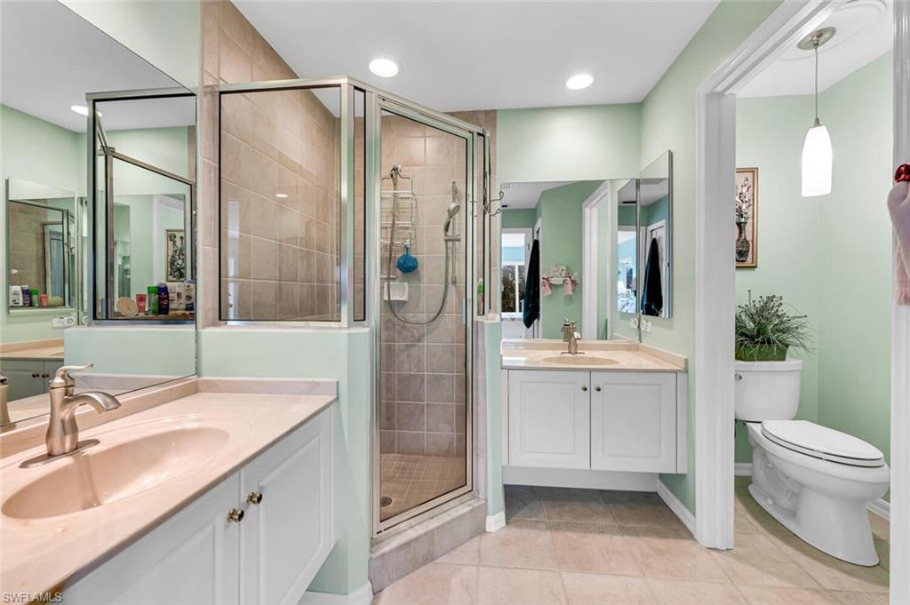 5735 Persimmon Way Naples, FL 34110 - Photo 20 of 49 Bathroom with tile patterned flooring, toilet, vanity, and walk in shower