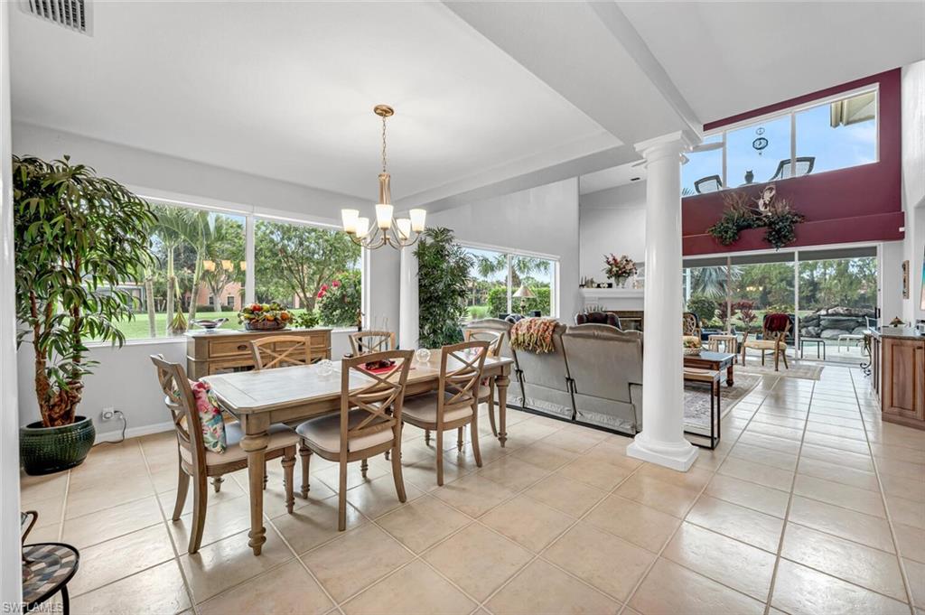 5735 Persimmon Way Naples, FL 34110 - Photo 5 of 49 Tiled dining room with an inviting chandelier, plenty of natural light, and ornate columns