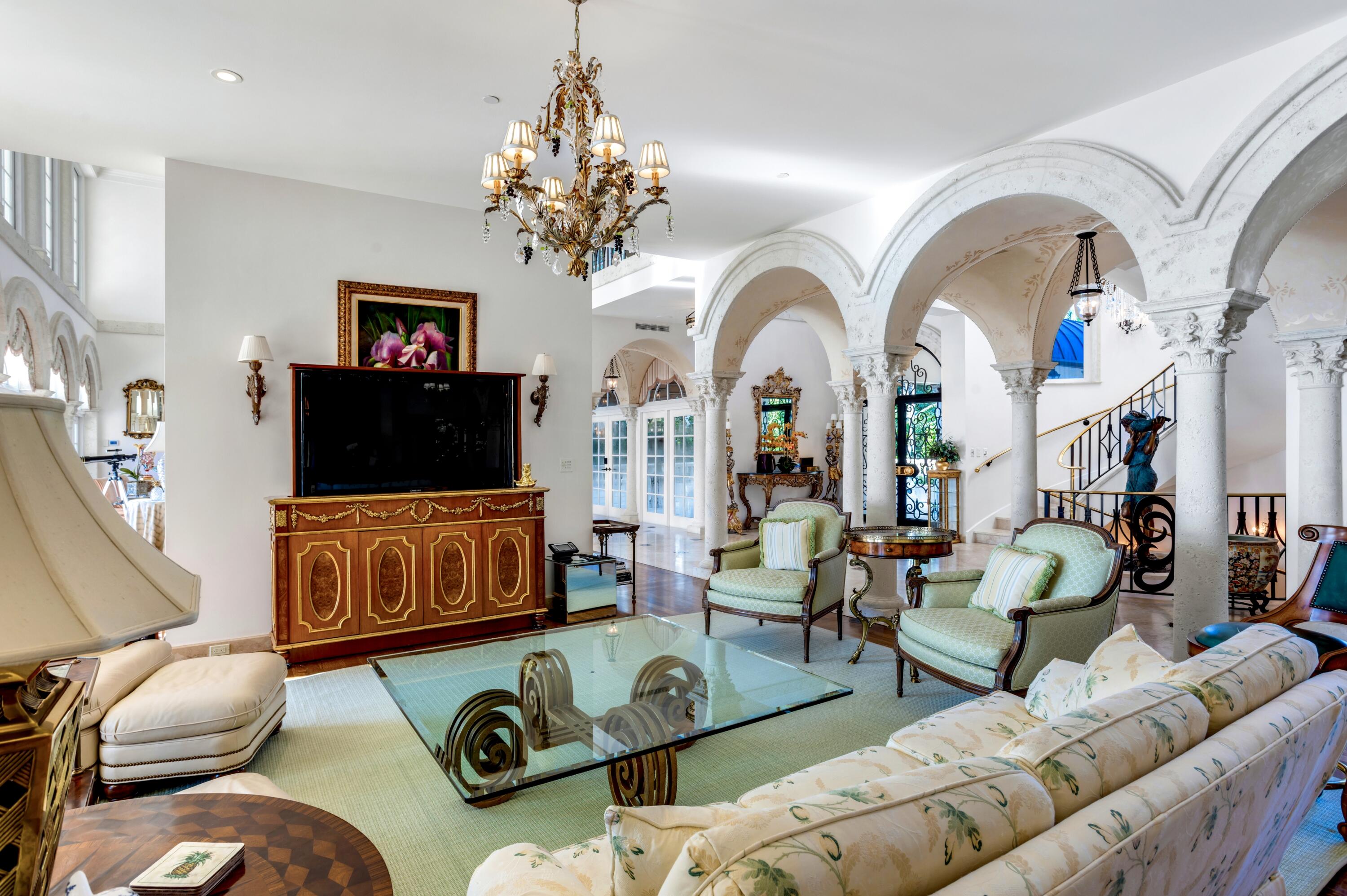 6133 North Ocean Boulevard Ocean Ridge, FL 33435 - Photo 15 of 64 a living room with furniture a chandelier and a flat screen tv