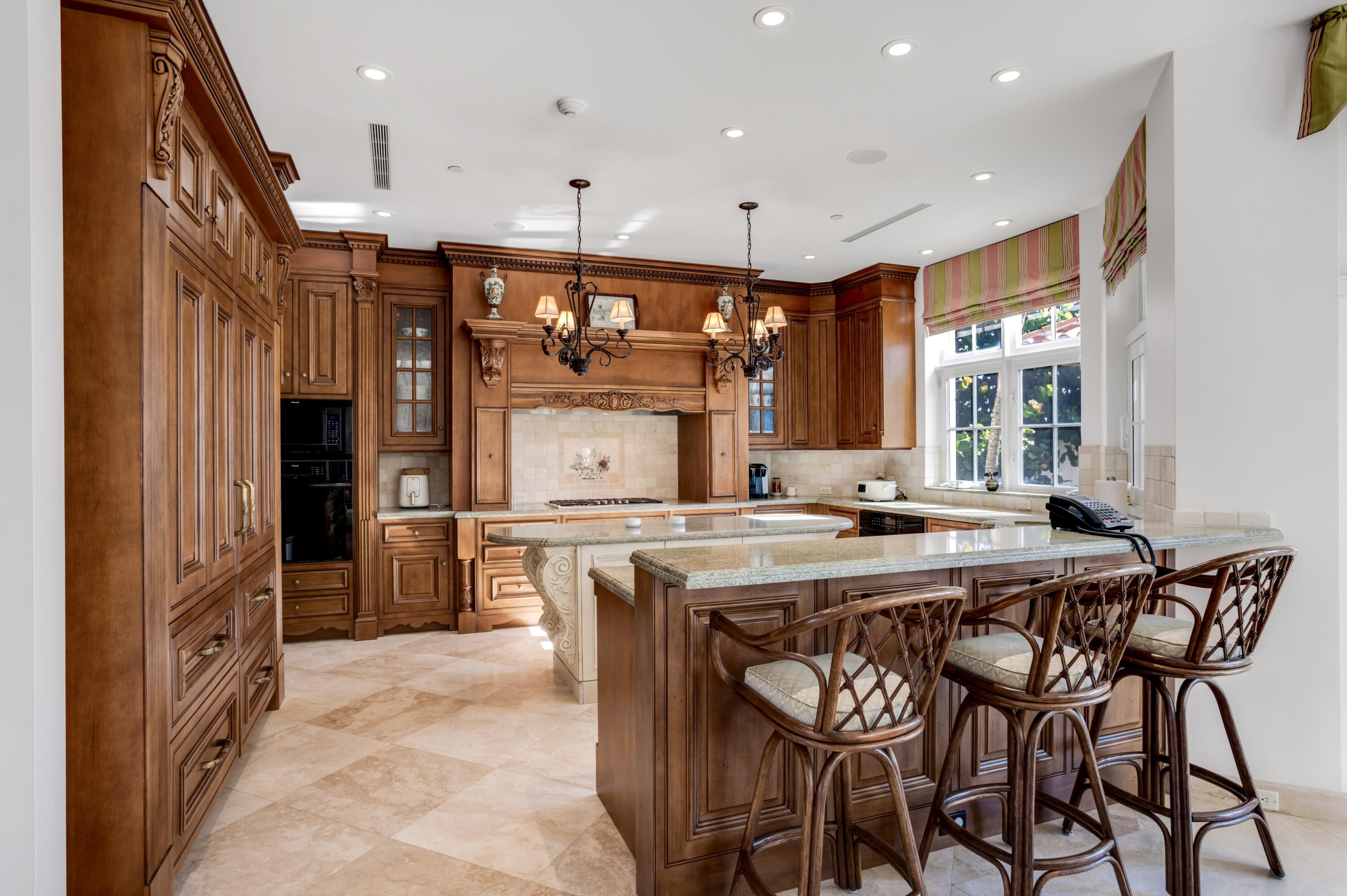 6133 North Ocean Boulevard Ocean Ridge, FL 33435 - Photo 18 of 64 a kitchen with stainless steel appliances granite countertop a stove and a refrigerator