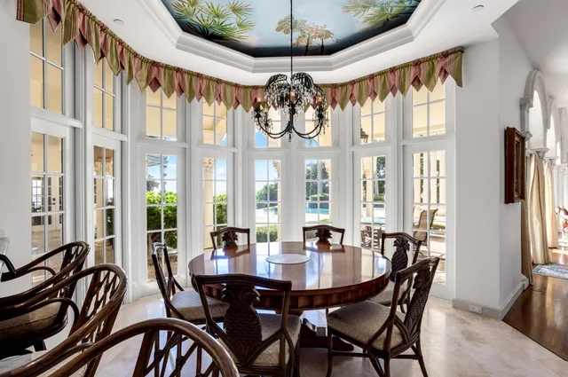 a view of a hallway with wooden floor and windows