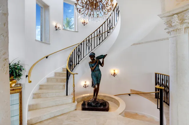 a spacious bedroom with a bed and a chandelier