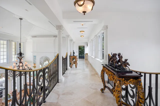a view of a hallway with closet and wooden floor