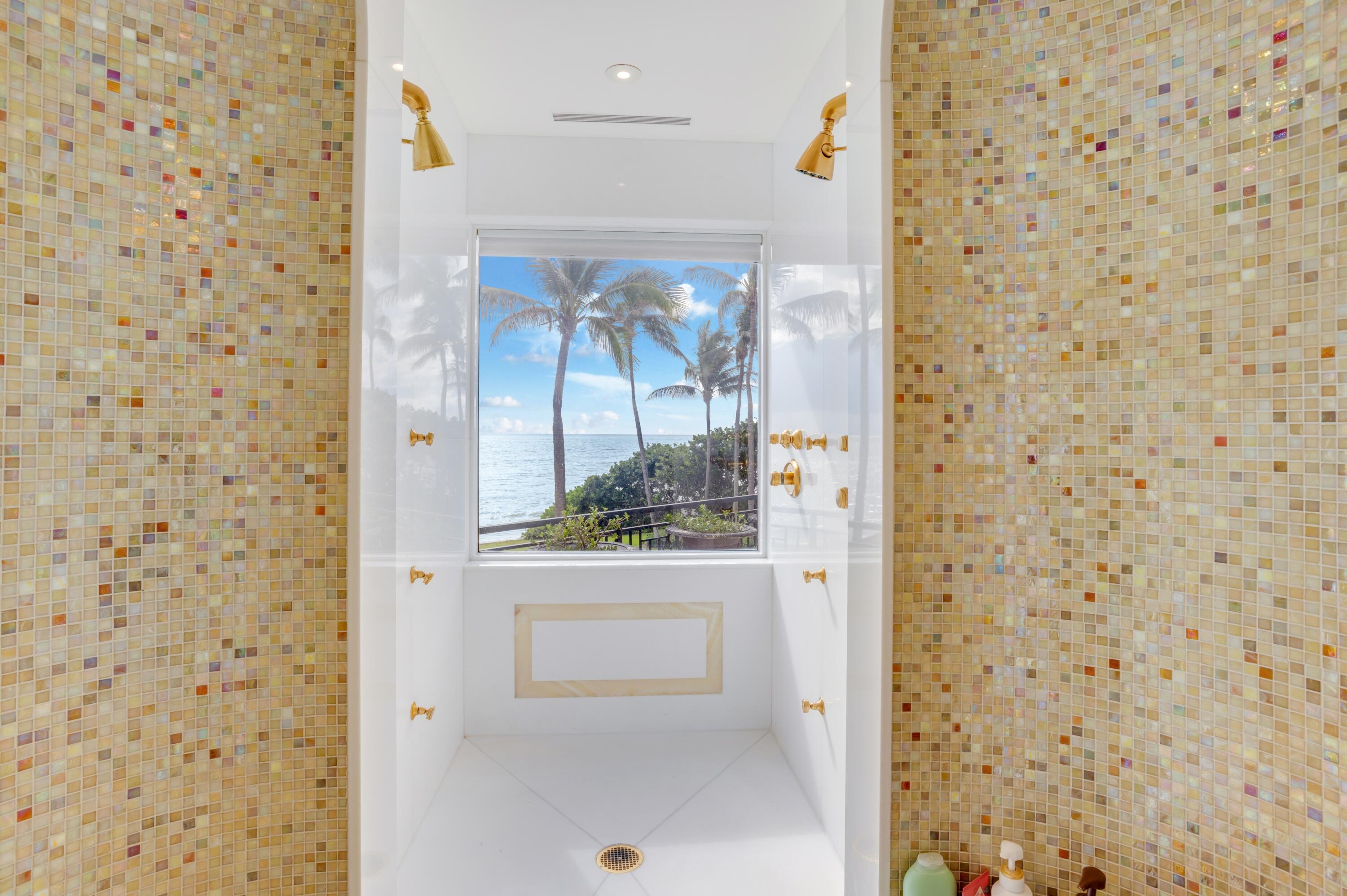 6133 North Ocean Boulevard Ocean Ridge, FL 33435 - Photo 32 of 64 a bathroom with a shower and a sink