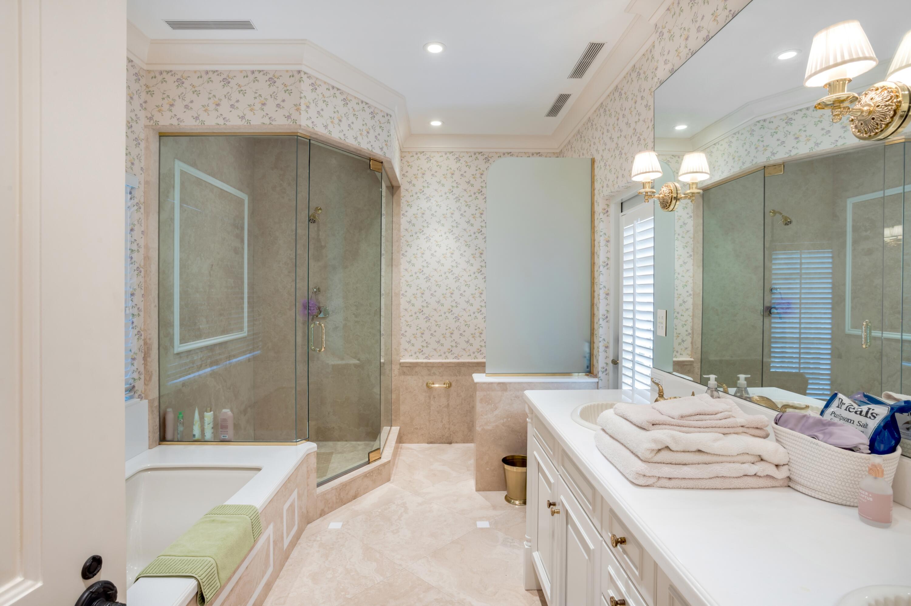 6133 North Ocean Boulevard Ocean Ridge, FL 33435 - Photo 37 of 64 a bathroom with a double vanity sink a toilet and shower