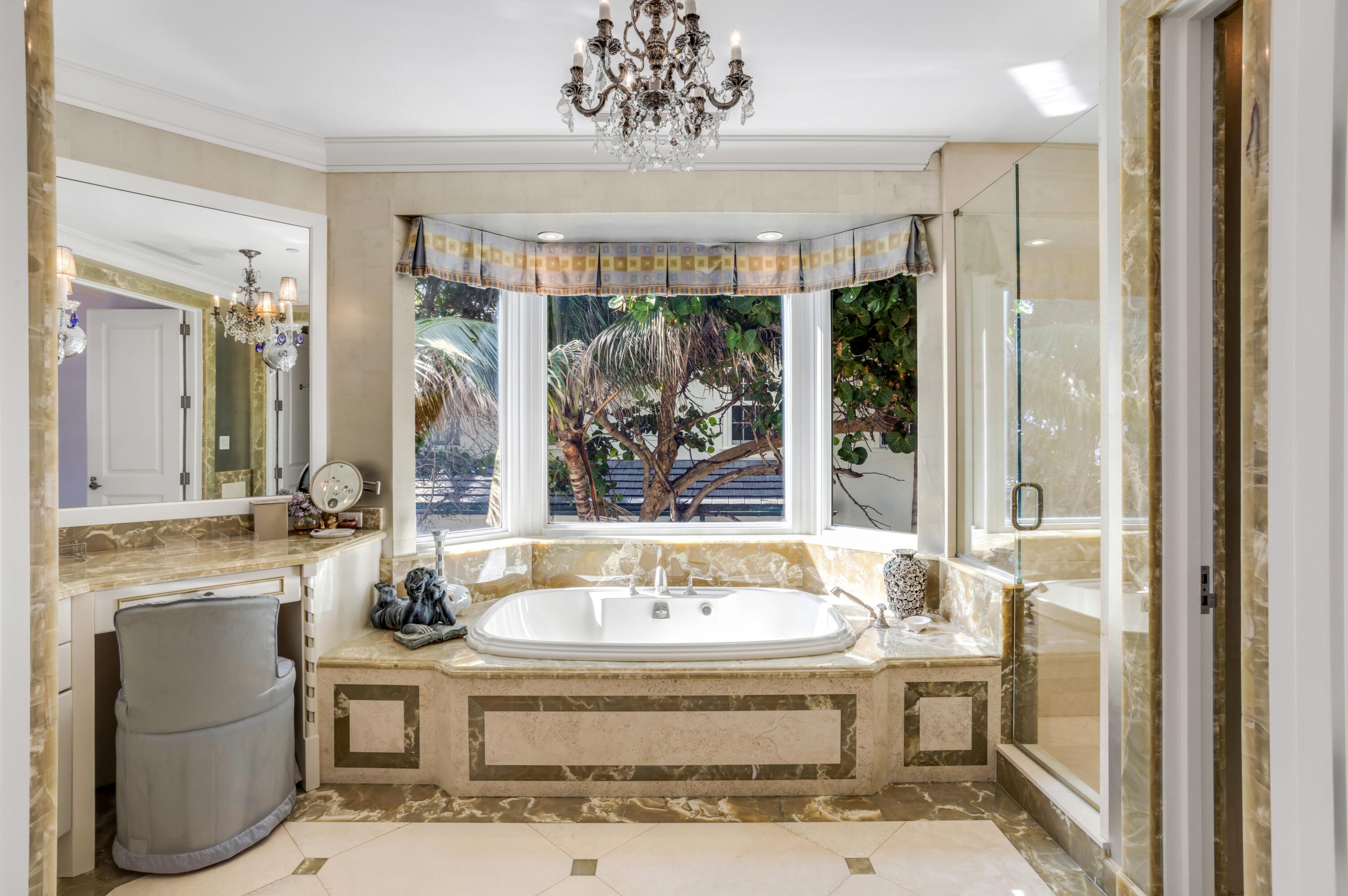6133 North Ocean Boulevard Ocean Ridge, FL 33435 - Photo 38 of 64 a spacious bathroom with a tub sink and large windows
