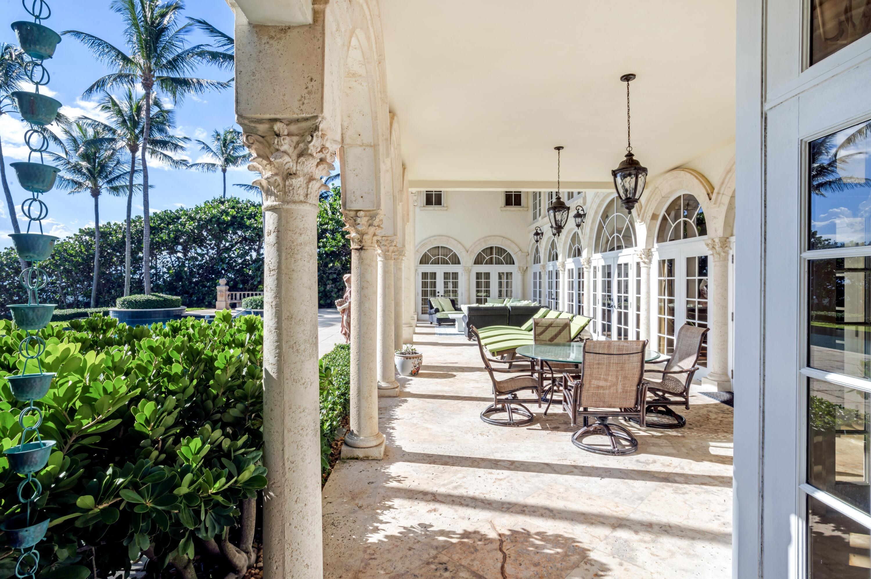 6133 North Ocean Boulevard Ocean Ridge, FL 33435 - Photo 52 of 64 a view of a patio with table and chairs and potted plants