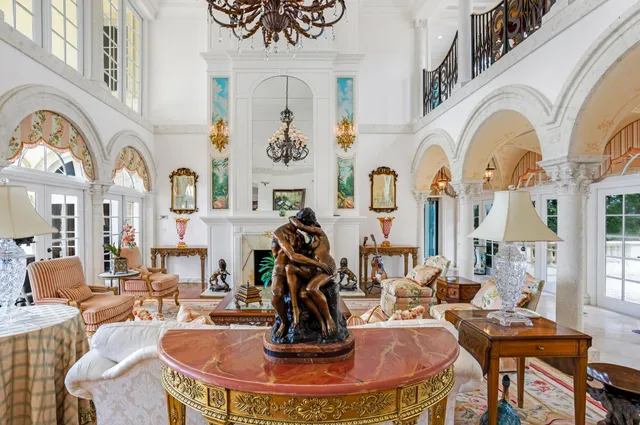 a living room with fireplace furniture and a large window