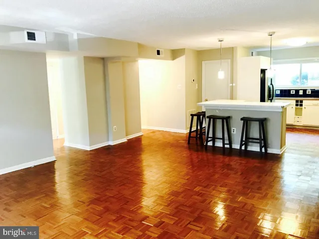 a view of dining room with kitchen island stainless steel appliances refrigerator sink and cabinets