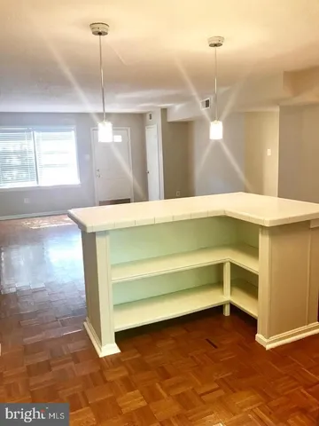 a view of a room with a ceiling fan and window