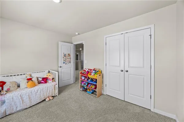 a bedroom with a bed and a couch