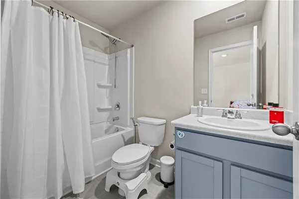 a spacious bathroom with a double vanity sink and a mirror
