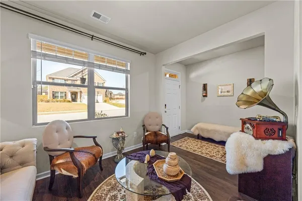 a living room with furniture and a chandelier