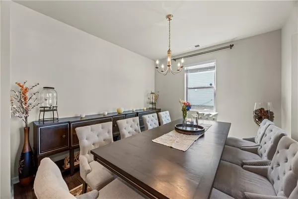 a view of a dining room with furniture and a chandelier