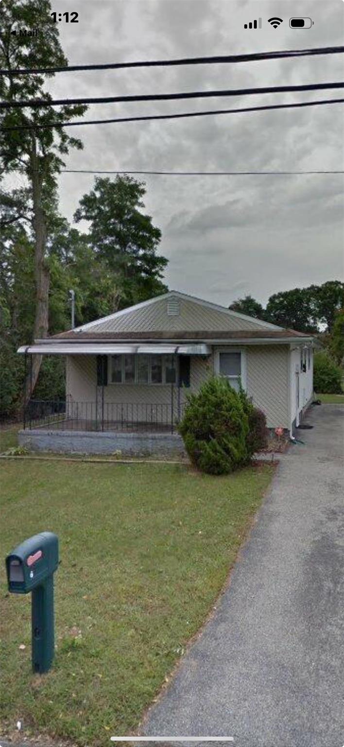 6 Poplar Road Amityville, NY 11701 - Photo 1 of 1 View of front of house featuring a porch and a front yard