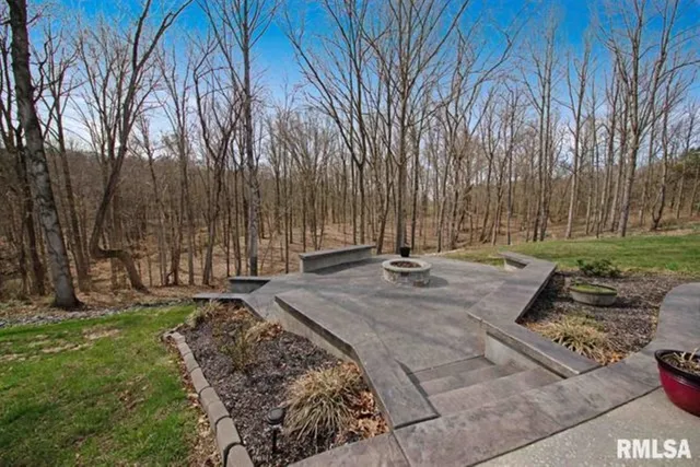 a view of a chair and table in the garden