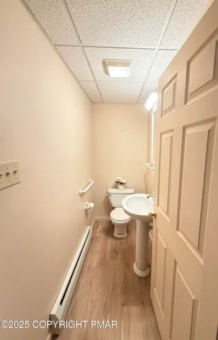 a view of a livingroom with wooden floor and a rug