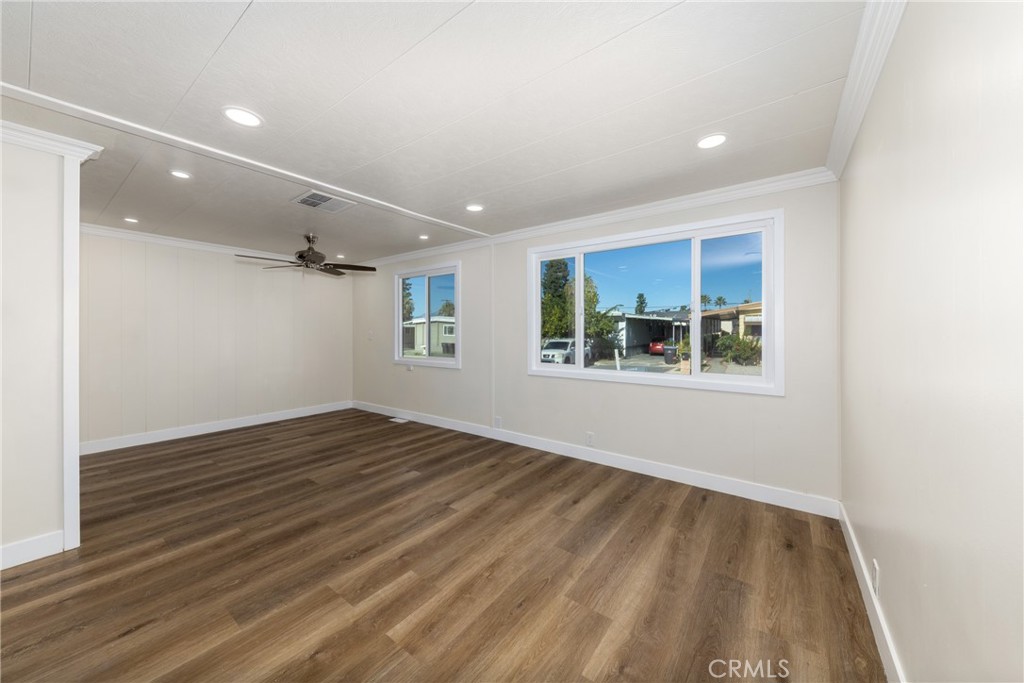 65 Round Table Drive, Unit 65 Riverside, CA 92507 - Photo 11 of 36 an empty room with wooden floor and windows