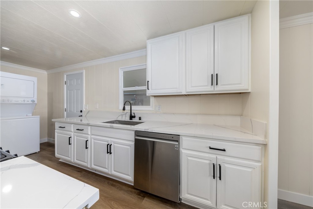 65 Round Table Drive, Unit 65 Riverside, CA 92507 - Photo 14 of 36 a kitchen with stainless steel appliances granite countertop a sink and cabinets with wooden floor