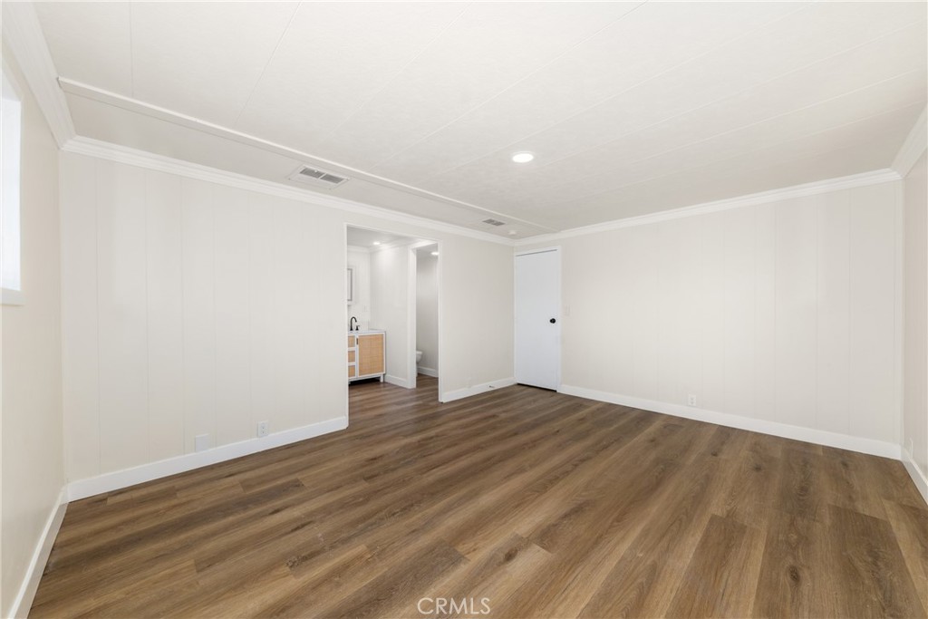 65 Round Table Drive, Unit 65 Riverside, CA 92507 - Photo 23 of 36 a view of an empty room with wooden floor