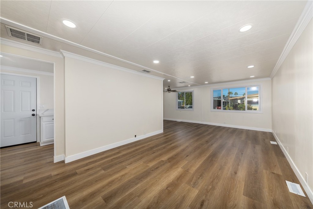 65 Round Table Drive, Unit 65 Riverside, CA 92507 - Photo 9 of 36 an empty room with wooden floor and windows