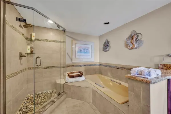 a bathroom with a tub and a shower