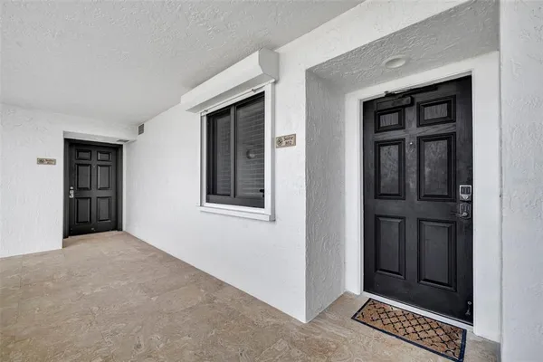 a view of an empty room with closet and workspace