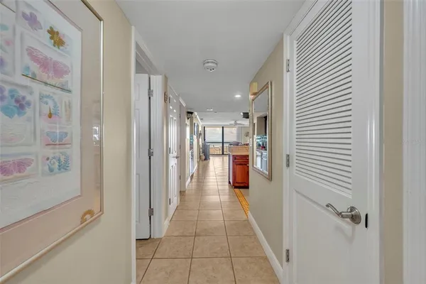 a hallway with a dining table and chairs
