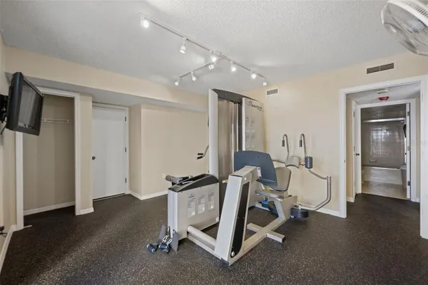 a room with gym equipment and a window