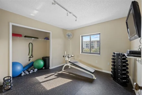 a room with gym equipment and a large window