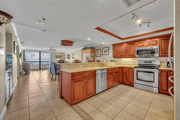 a kitchen with stainless steel appliances granite countertop a stove and cabinets