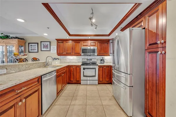 a kitchen with stainless steel appliances granite countertop a refrigerator and a sink