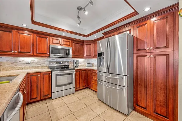 a kitchen with stainless steel appliances granite countertop a refrigerator oven a sink and dishwasher